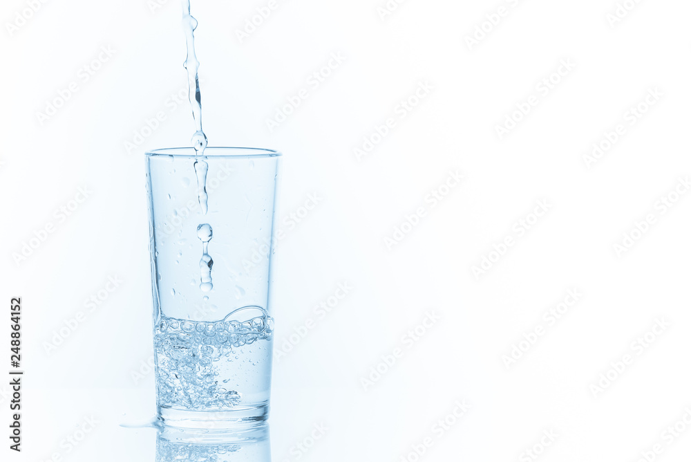 Pouring water into glass on white background. Photo with copy space. Pouring water into glass on white background. Photo with copy space.