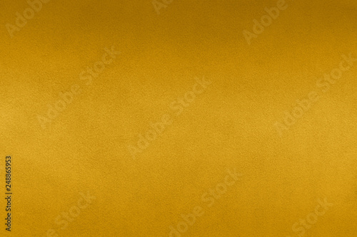 Luxury gold textile background. Silk cloth texture. Fabric pattern.