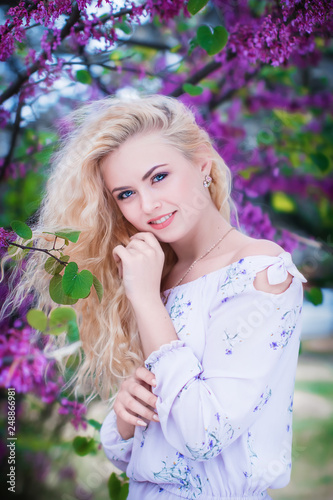 blonde girl in the Park with lilac
