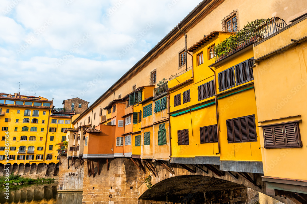 Florence, Italy Firenze orange yellow colorful building closeup on Ponte Vecchio by Arno river during summer morning in Tuscany with nobody vibrant