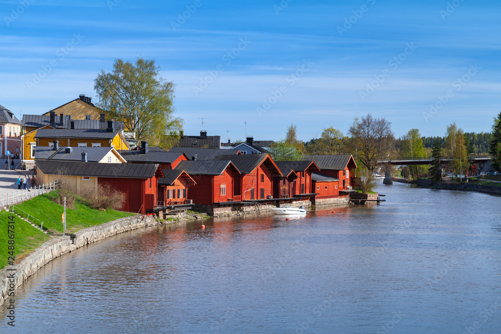 Old wooden houses are on the river coast