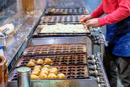 Takoyaki ball process to cooking by hand , takoyaki (octopus dumplings) famous Japanese snack food , Takoyaki traditional food Osaka in Japan