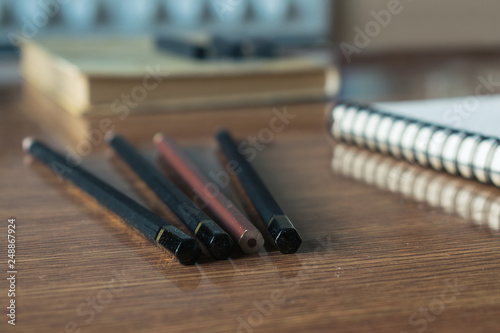 Close-up view of artist's or designer's table. Pencils, sharpner and eraser photo