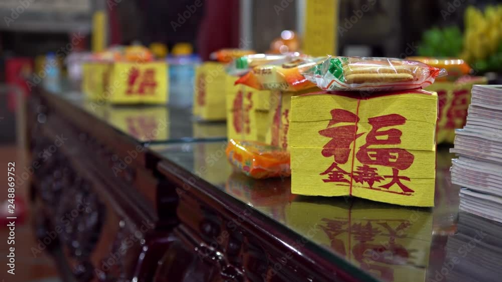 4k, People offerings food and joss paper in templo of Tainan Grand Matsu Temple. Kanjin is a large paper squares with golden metallic rectangle, burned for gods and spirits or ancestors in Taiwan-Dan 4k, People offerings food and joss paper in templo of Tainan Grand Matsu Temple. Kanjin is a large paper squares with golden metallic rectangle, burned for gods and spirits or ancestors in Taiwan-Dan