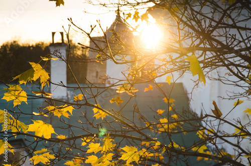 Autumn foliage and some chutch on background. sunny day. photo
