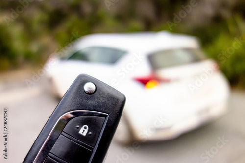 Black key fob for opening a white modern car