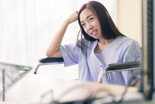 Patients woman sitting on a wheelchair in a rehabilitation room.