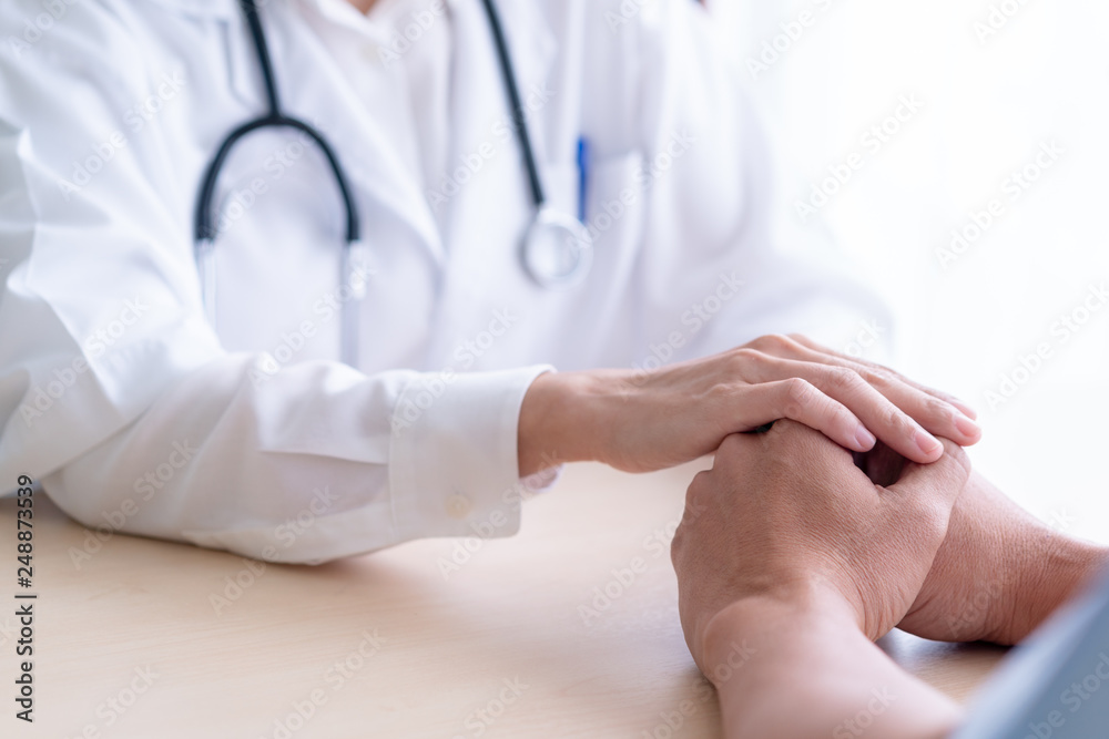 Woman doctor holds hands for male patients to encourage. Woman doctor holds hands for male patients to encourage.