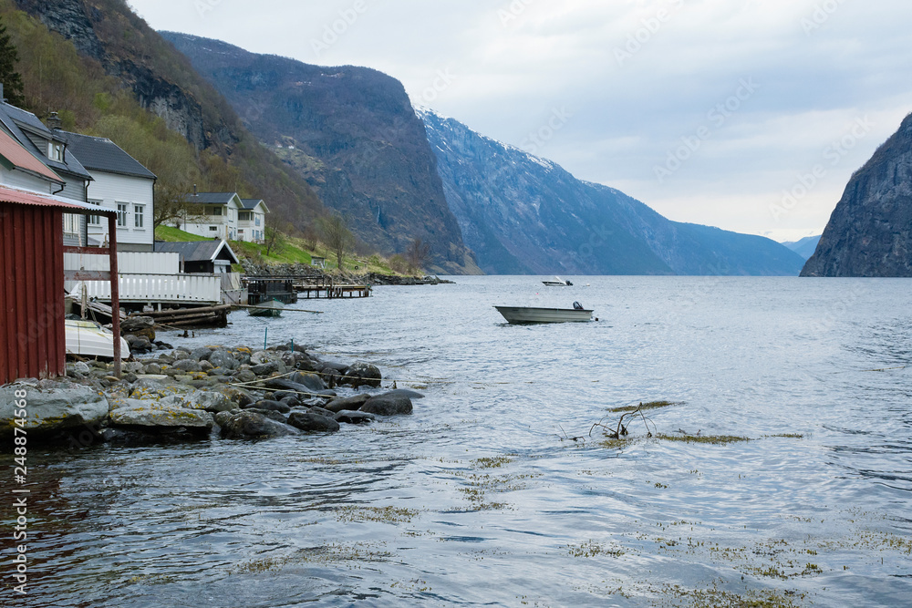 Undredal is a small village in the municipality of Aurland in Sogn og Fjordane county, Norway. Traditional Norwegian houses and a fishing boat on the shore of the fjord