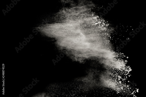 White talcume powder explosion on black background. White dust splashing.