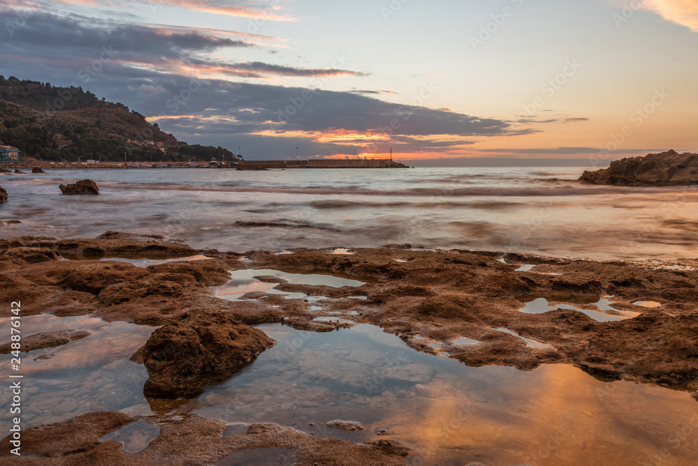 Long Exposure of the Mediterranean Sea Coast in Southern Italy at Sunset