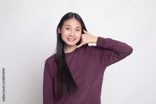 Young Asian woman show with phone gesture. © halfbottle
