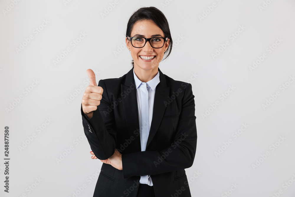 Portrait of caucasian businesswoman 30s in formal wear and eyeglasses standing in the office, isolated over white background Portrait of caucasian businesswoman 30s in formal wear and eyeglasses standing in the office, isolated over white background