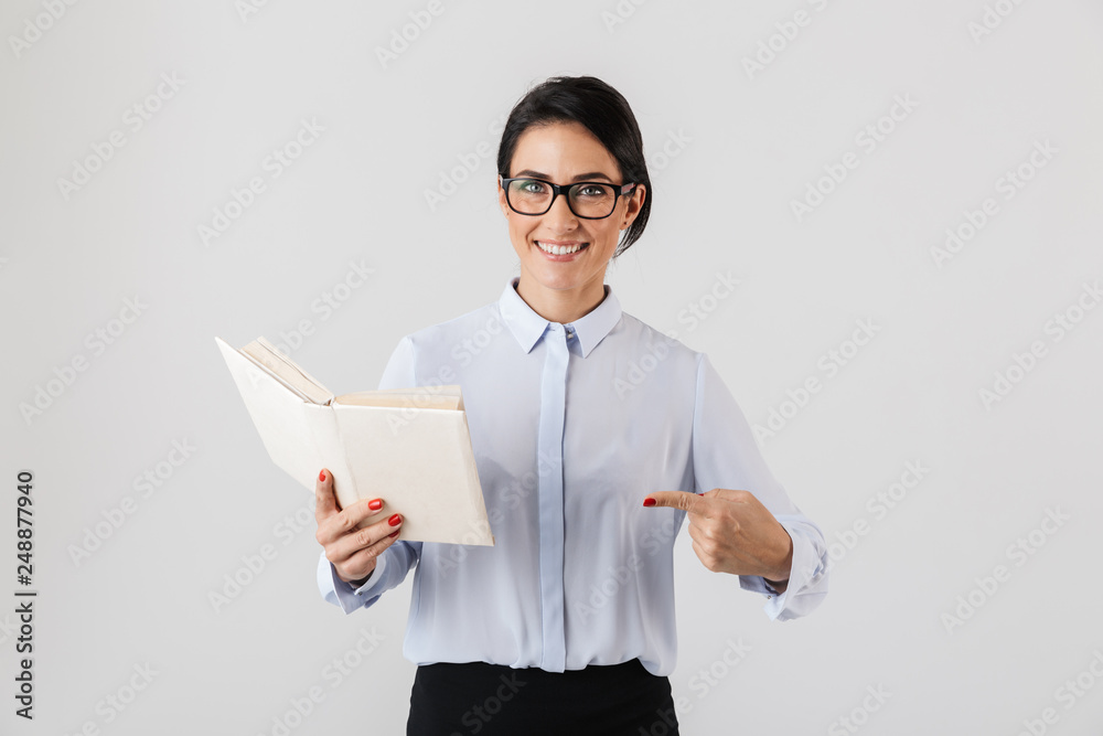 Photo of pretty female worker wearing eyeglasses reading book in the office, isolated over white background Photo of pretty female worker wearing eyeglasses reading book in the office, isolated over white background