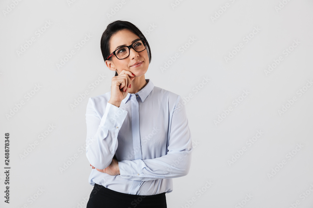 Image of attractive secretary woman wearing eyeglasses standing in the office, isolated over white background