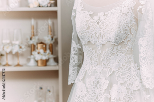 lace wedding dress on a mannequin in a wedding clothing store.