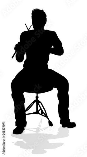 A drummer musician drumming drums in detailed silhouette