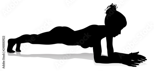 A silhouette of a woman in a yoga or pilates pose 