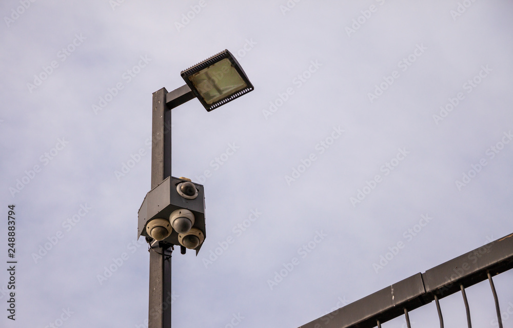 Outdoor security cameras and lights isolated against the sky Outdoor security cameras and lights isolated against the sky