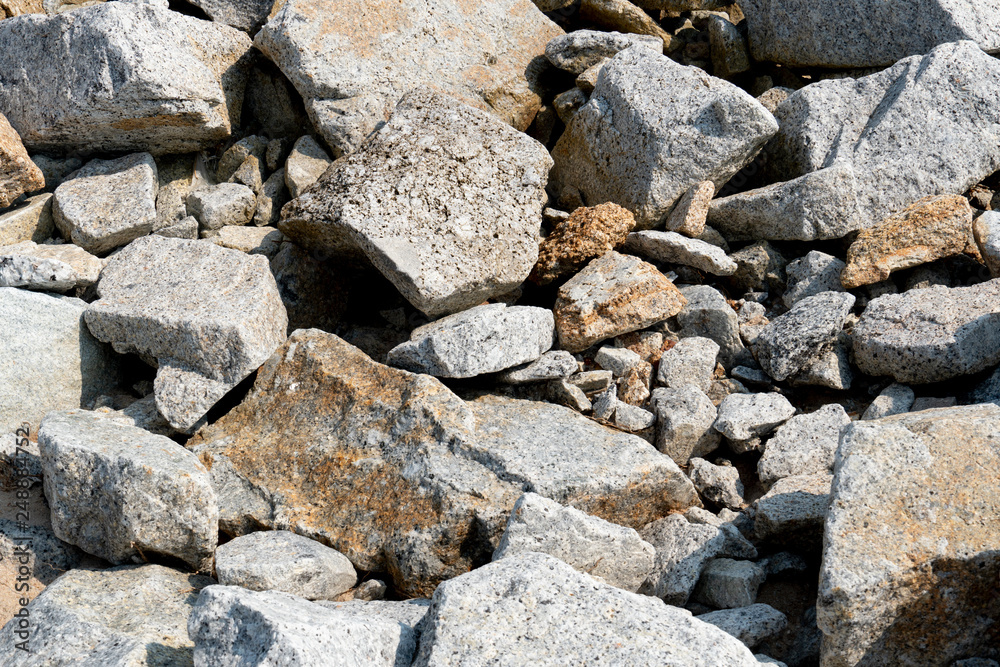 The stones that are stacked together, both small and large, are mixed together.
