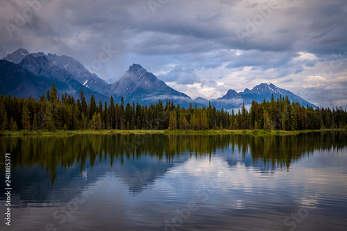 Mountains reflecting in the calm waters of Spillway Lake in Peter Lougheed Provincial Park  Alberta  Canada