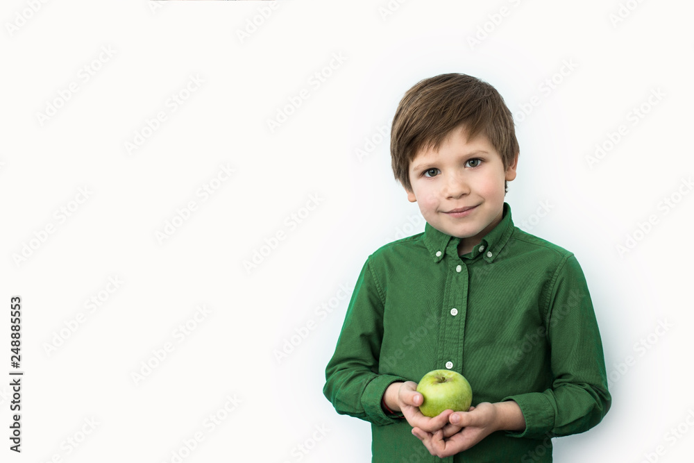 boy holds a green apple in his hands, emotions boy holds a green apple in his hands, emotions