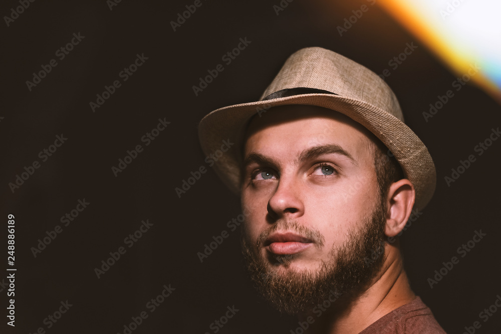 portrait of young man with a hat hippie hipster look face model concept idea strong eyes barb night photography