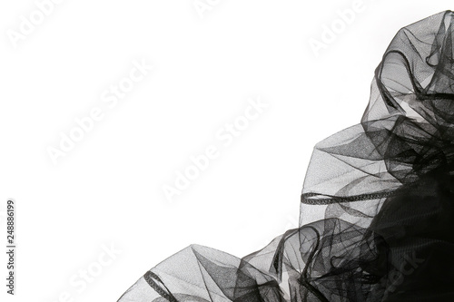 Abstract composition of black tulle material  isolated on white background. Waving shape of tulle fabric with copy space.