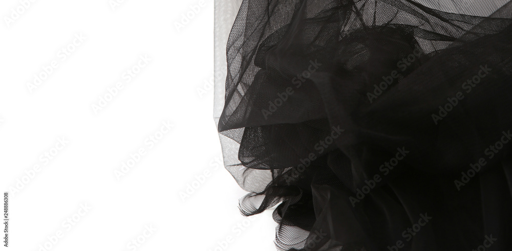 Abstract composition of black tulle material isolated on white background.  Waving shape of tulle fabric with copy space. Stock Photo