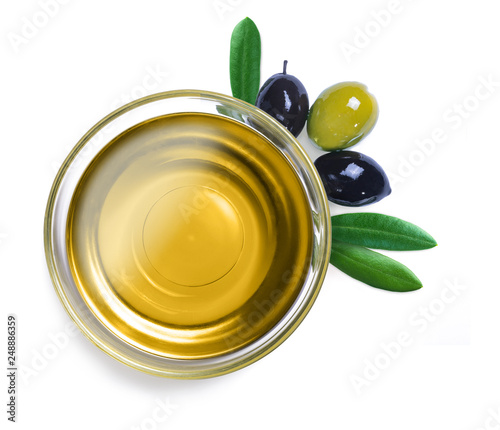 Glass bowl with olive oil with leaves on white