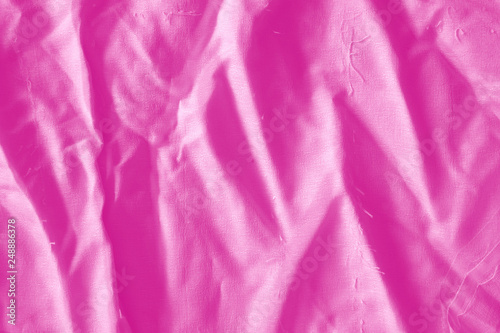 Elegant pink textile background. Silk cloth texture. Fabric pattern.