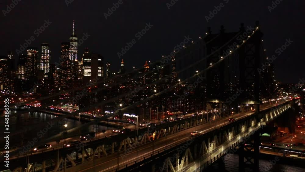 night flying next to Manhattan Bridge revealing downtown NYC night flying next to Manhattan Bridge revealing downtown NYC