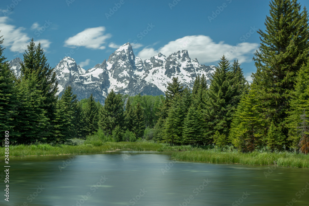 Grand Teton Range Framed  by Trees with Lake in Foreground