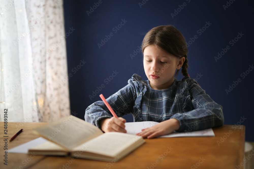 funny child girl doing homework and showing tongue funny child girl doing homework and showing tongue