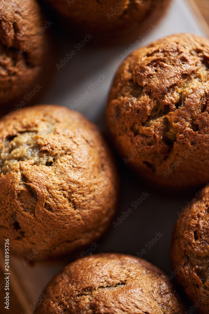 Freshly baked muffins cooling on a serving board Freshly baked muffins cooling on a serving board