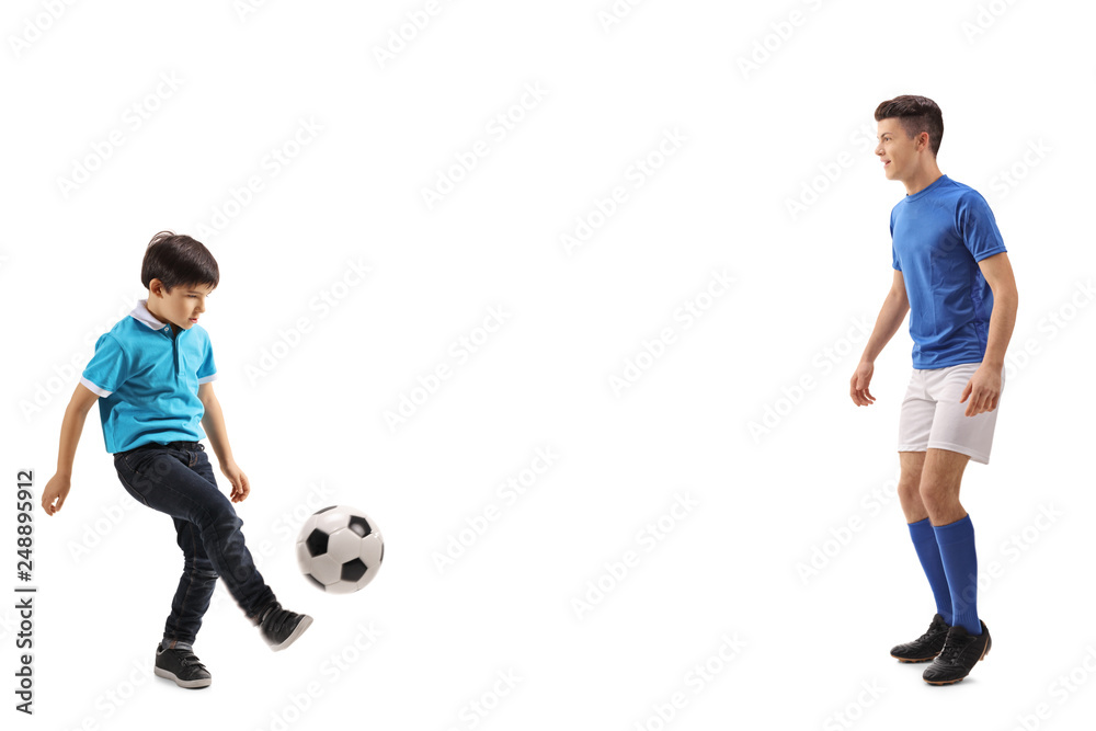 Little boy playing soccer with an older boy Little boy playing soccer with an older boy