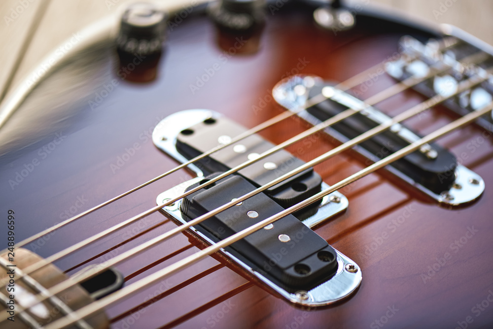 Guitar Lessons. Close-up view of electric guitar body with metal strings, volume and tone controls Guitar Lessons. Close-up view of electric guitar body with metal strings, volume and tone controls