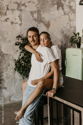  beautiful loving couple kisses and hugs in the kitchen