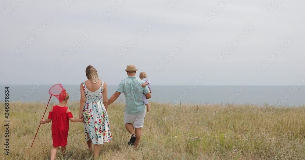 Family trip - parents with children on summer vacation, trip to the sea Family trip - parents with children on summer vacation, trip to the sea