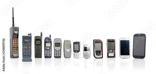 Old Mobile Phone from past to present on white background. photo