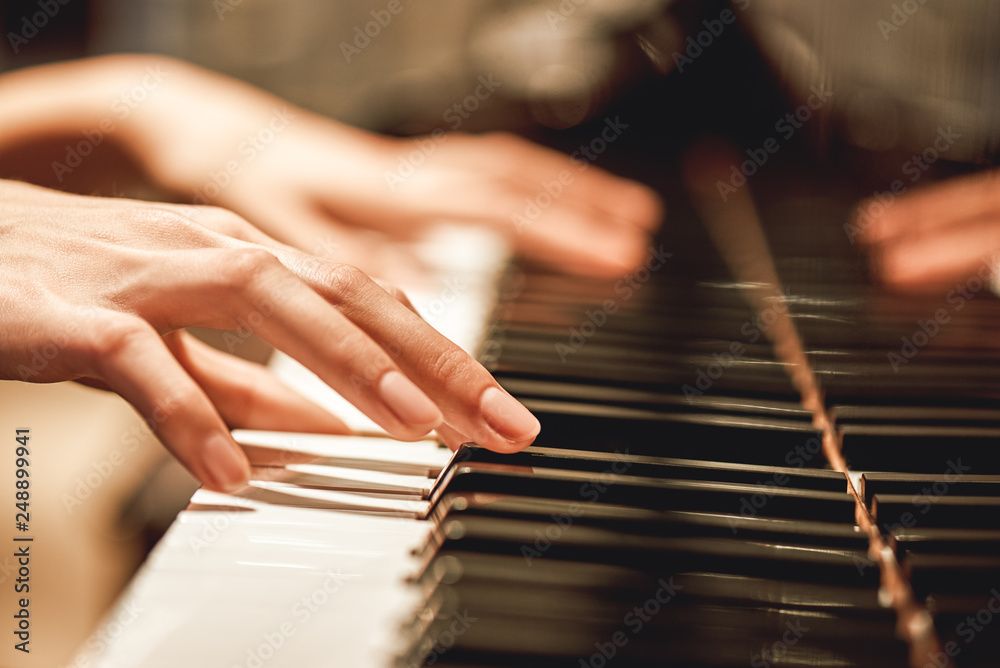 Beautiful Piano Melody...Close up view of female hands playing on piano her favorite classical music