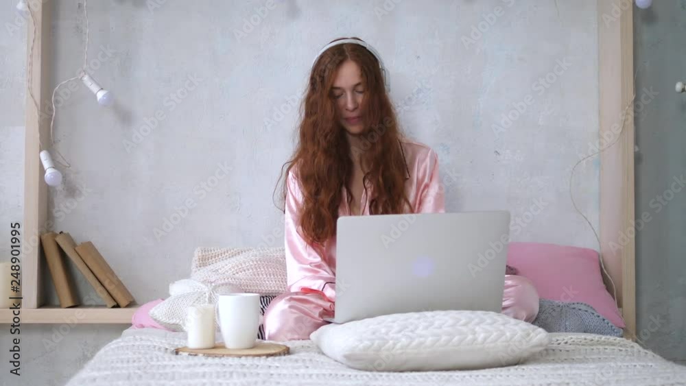 Young Woman Relaxing On Bed Using Laptop Computer For Video Call Young Woman Relaxing On Bed Using Laptop Computer For Video Call