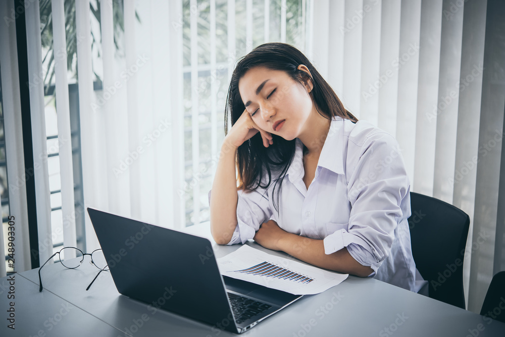 Asian woman working in office,young business woman stressed from work overload with a lot file on the desk,Thailand people Asian woman working in office,young business woman stressed from work overload with a lot file on the desk,Thailand people