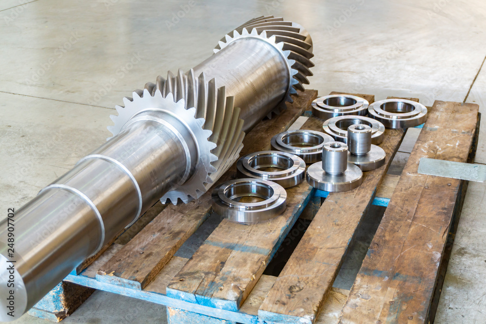 New shaft gear on a rack after production. New shaft gear on a rack after production.