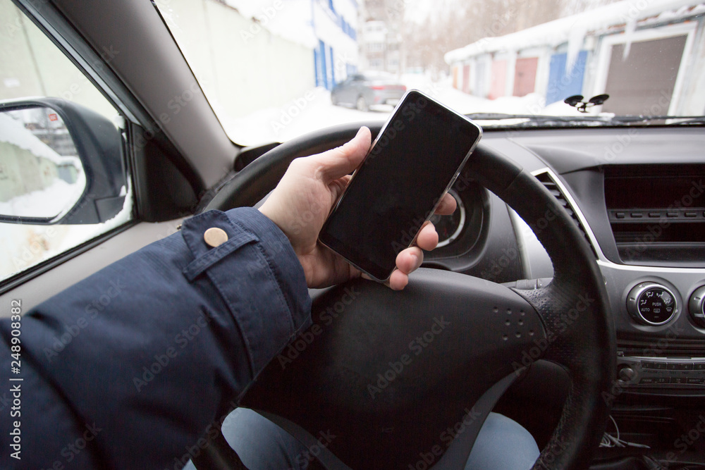 Man talking on the phone while driving a car Man talking on the phone while driving a car
