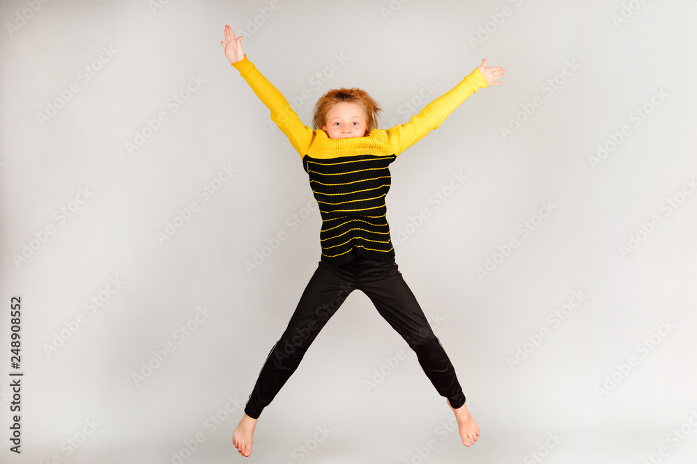 Fototapeta premium The girl jumps up, arms and legs in different directions.