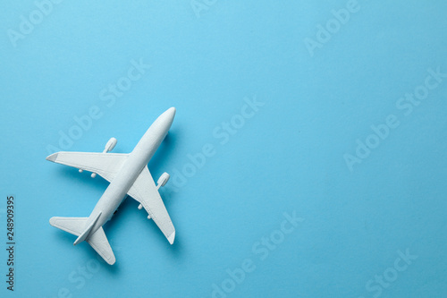 White passenger plane on blue background. Copy space for text.