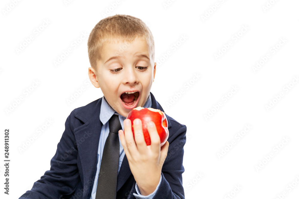 Schoolboy eating an apple, close-up, isolated on white background Schoolboy eating an apple, close-up, isolated on white background