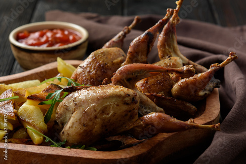 Grilled quails with fried potatoes and tomato dip.