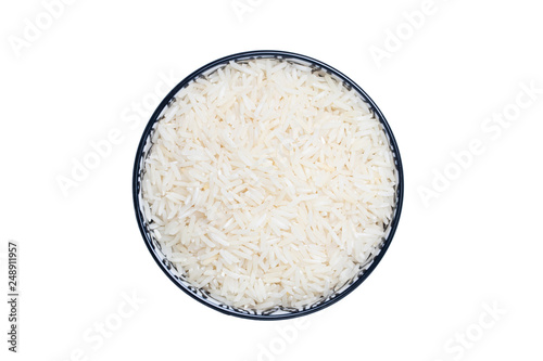 Vegetable food. Macro of a bowl with uncooked raw rice grains isolated on a white background. Healthy eating. Top view with space for product montage.